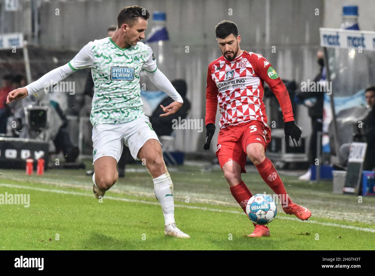 Germany ,Fuerth, Sportpark Ronhof Thomas Sommer - 22 Jan 2022 - Fussball, 1.Bundesliga - SpVgg Greuther Fuerth vs. FSV Mainz 05  Image: (fLTR) Paul Seguin (SpVgg Greuther Fürth,33), Aaron Martin (Mainz, 3)  DFL regulations prohibit any use of photographs as image sequences and or quasi-video Stock Photo