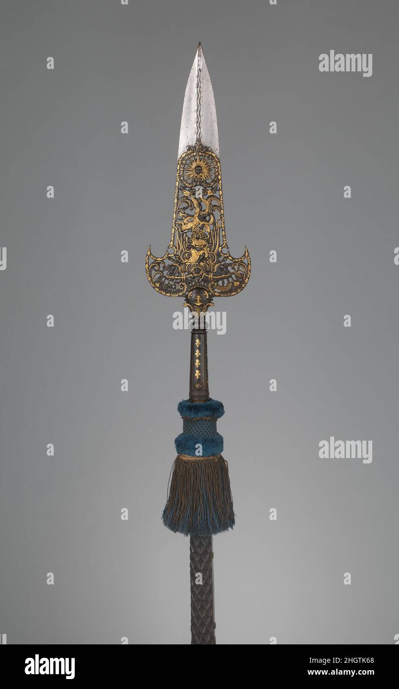 Partisan Carried by the Bodyguard of Louis XIV (1638–1715, reigned from 1643) ca. 1679 Jean Berain French This partisan, along with two like it also in the Metropolitan Museum's collection (acc. nos. 04.3.64, .65), are thought to have been carried by the Gardes de la Manche (literally, “guards of the sleeve,” indicating their close proximity to the king), an elite unit of the bodyguard of Louis XIV. This example is from a small group designed by Jean Bérain the Elder (1637–1711) for the marriage of Louis’s niece Marie-Louise d’Orléans to Carlos II of Spain in 1679. The decoration features a su Stock Photo