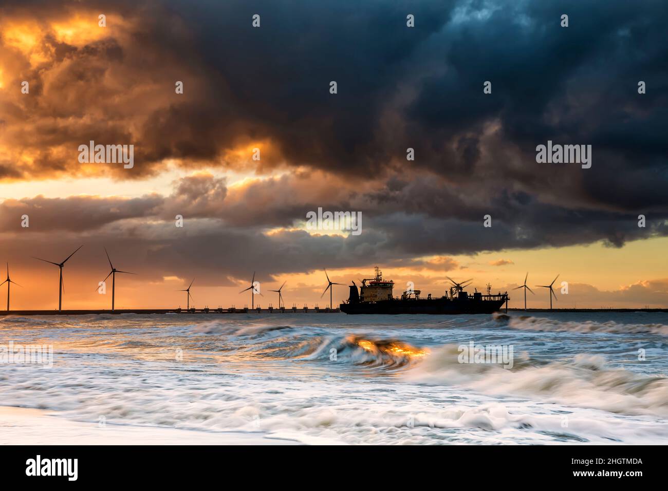 big ship on North sea waves at sunrise, Netherlands Stock Photo