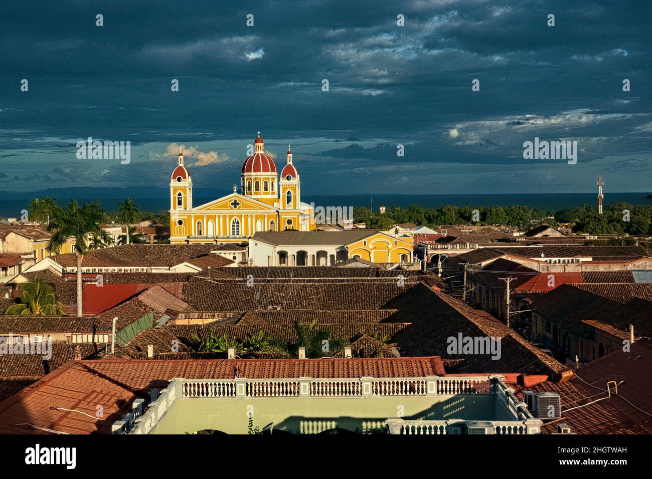 The beautiful neoclassical Granada Cathedral  and the roofs of colonial Granada, Nicaragua Stock Photo