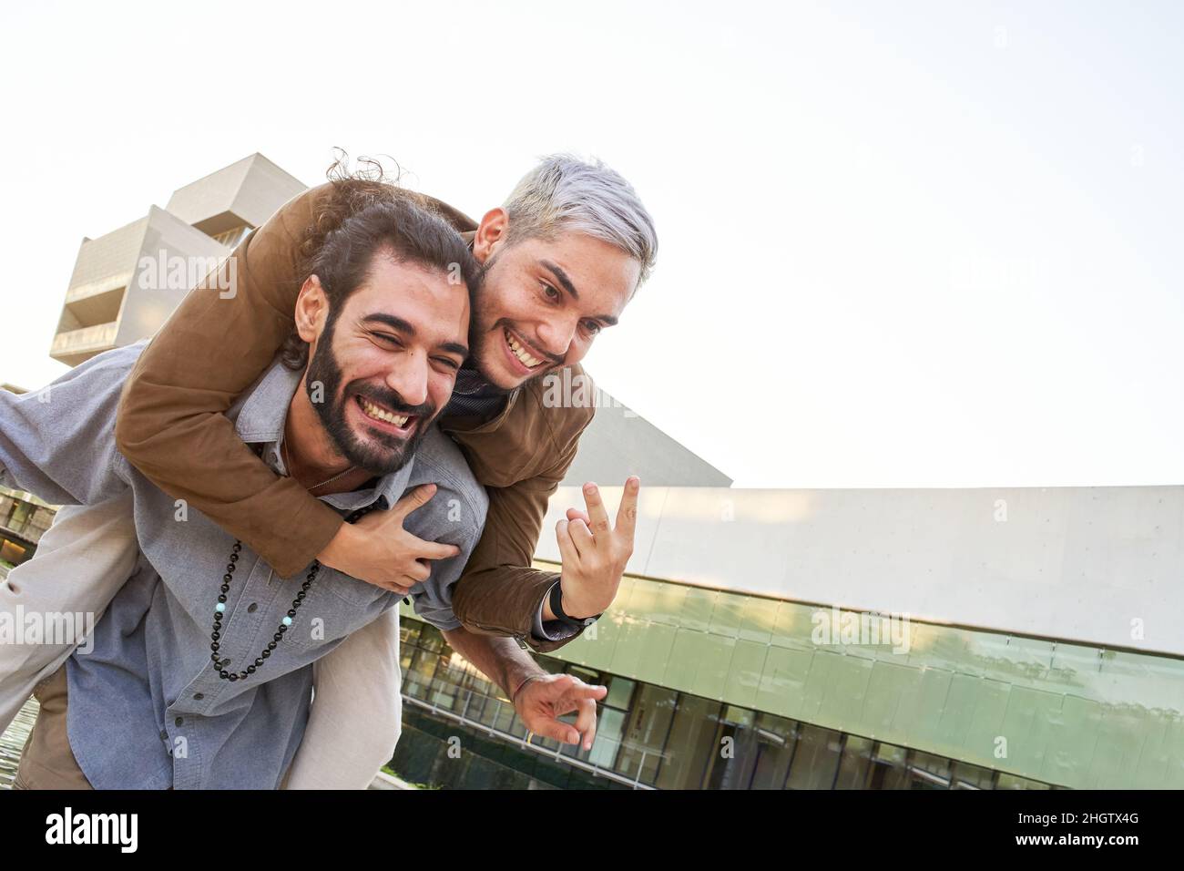Happy gay couple man embrace in love outdoors. Cheerful LGTB people having fun together Stock Photo