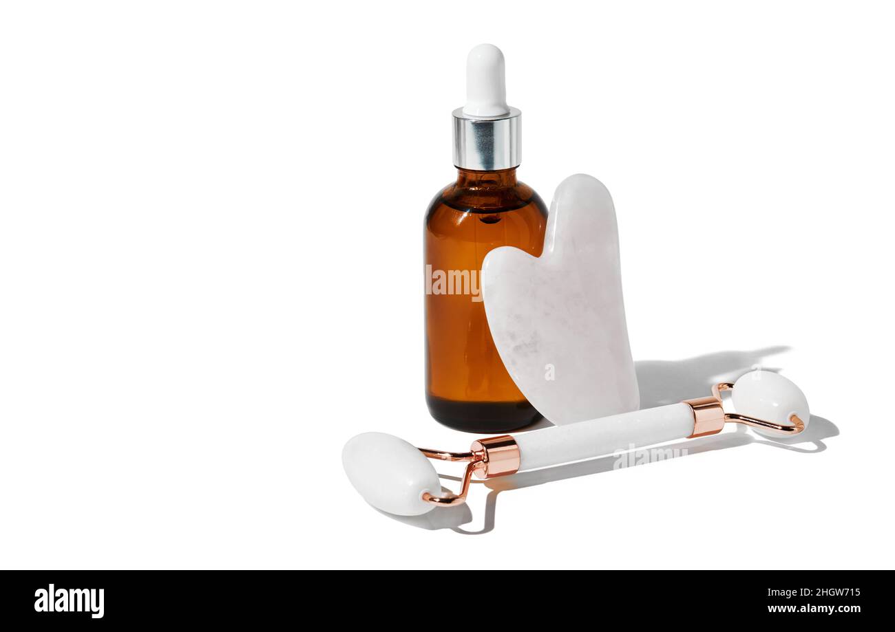 Gua Sha massage tools for better blood circulation and essential oil isolated on white background with clipping path. Home skin care concept. Stock Photo