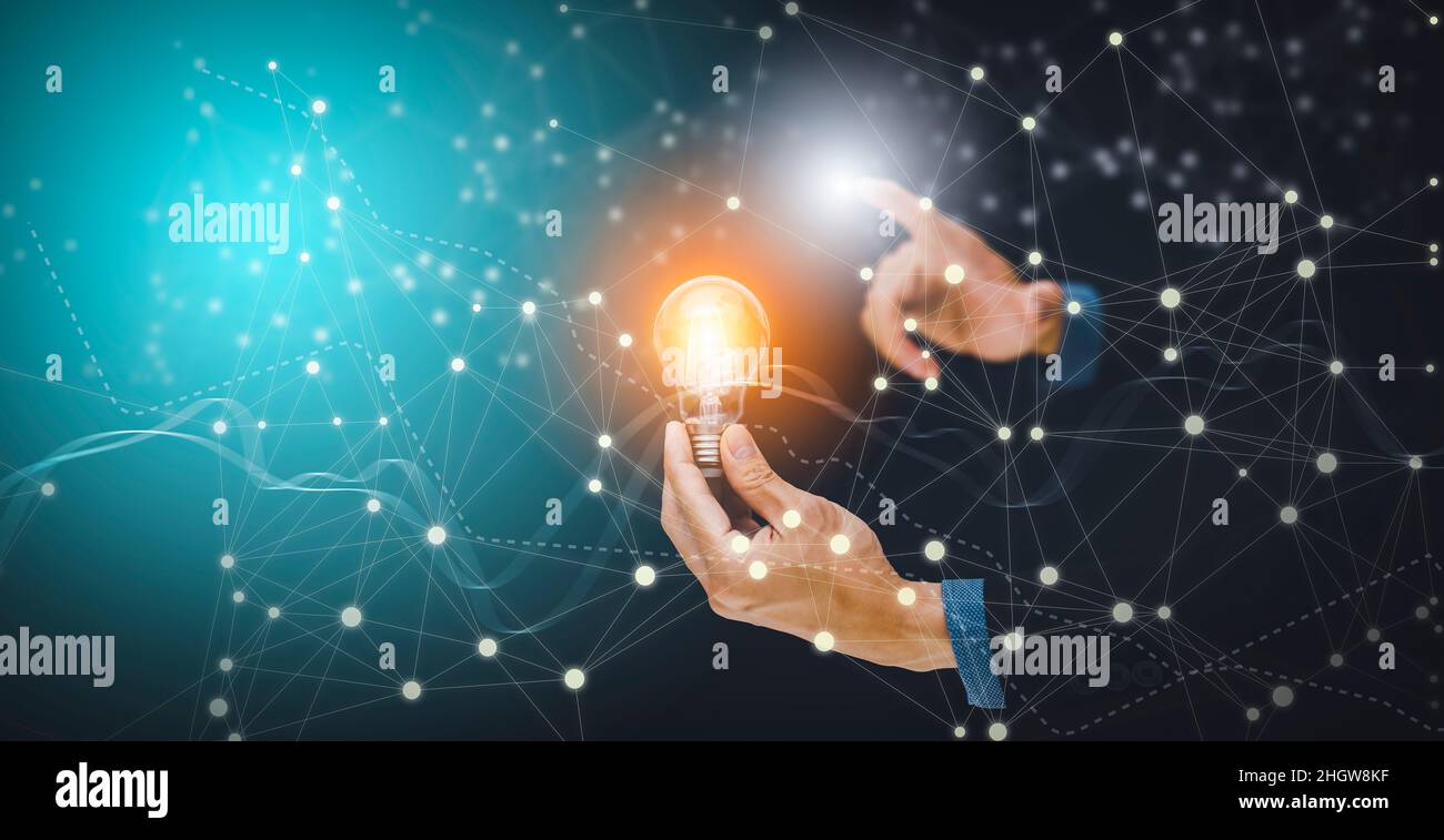 The Man hand holding light bulb with line connect and working on the ...