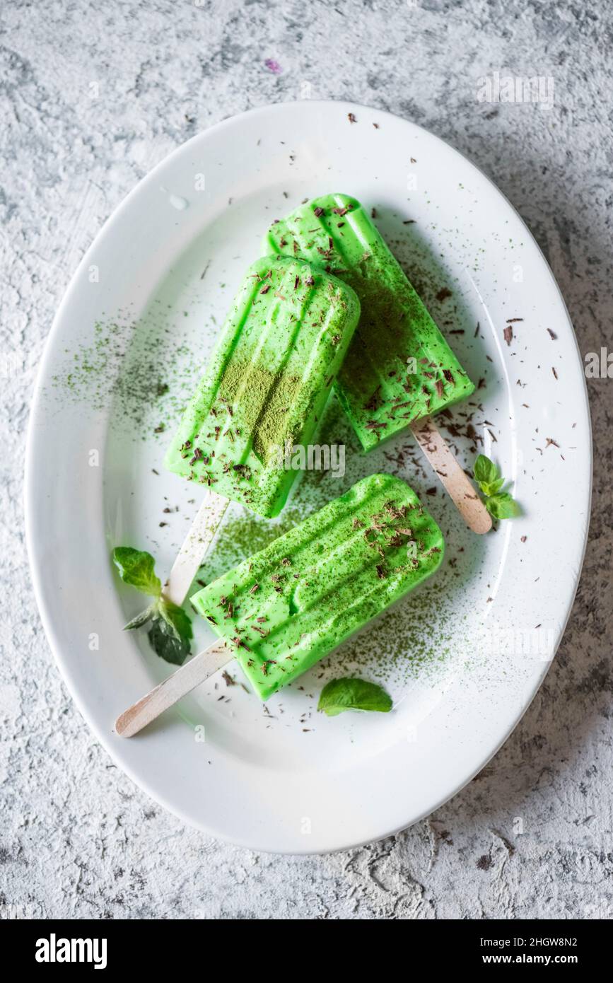 Matcha popsicles ice cream on grey background. Top view. Stock Photo