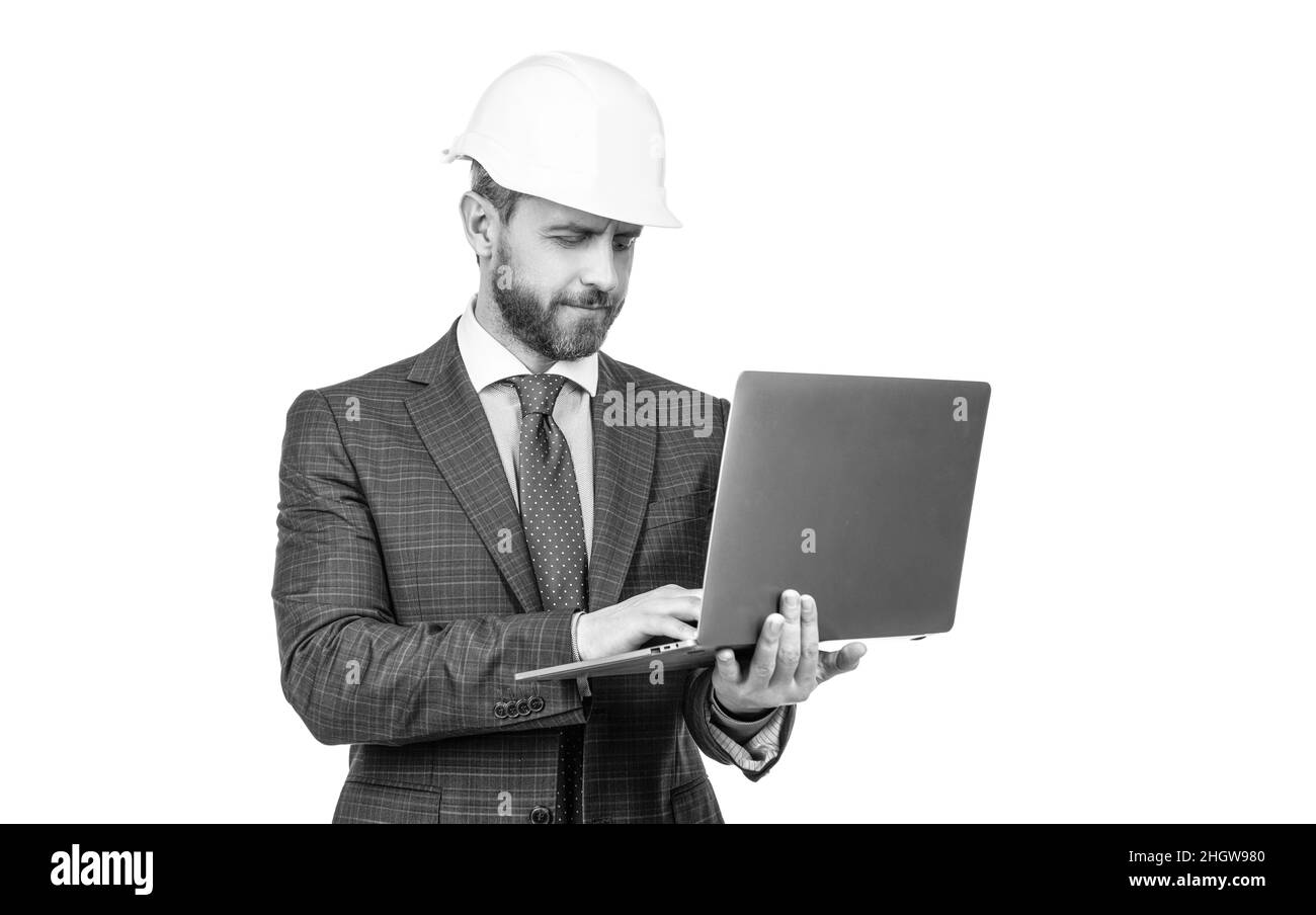 confident businessman man in suit and helmet hold computer isolated on white, business Stock Photo