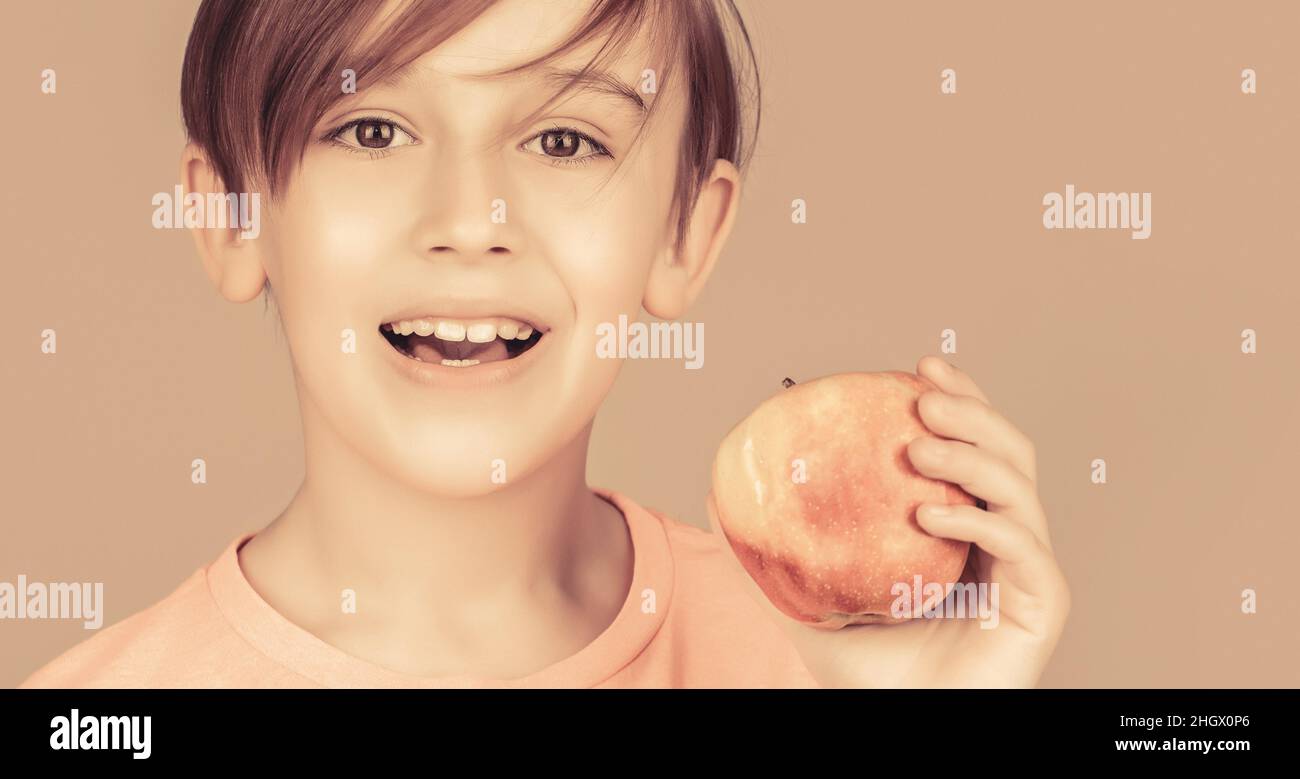 Little boy eating apple. Boy apples showing. Child with apples