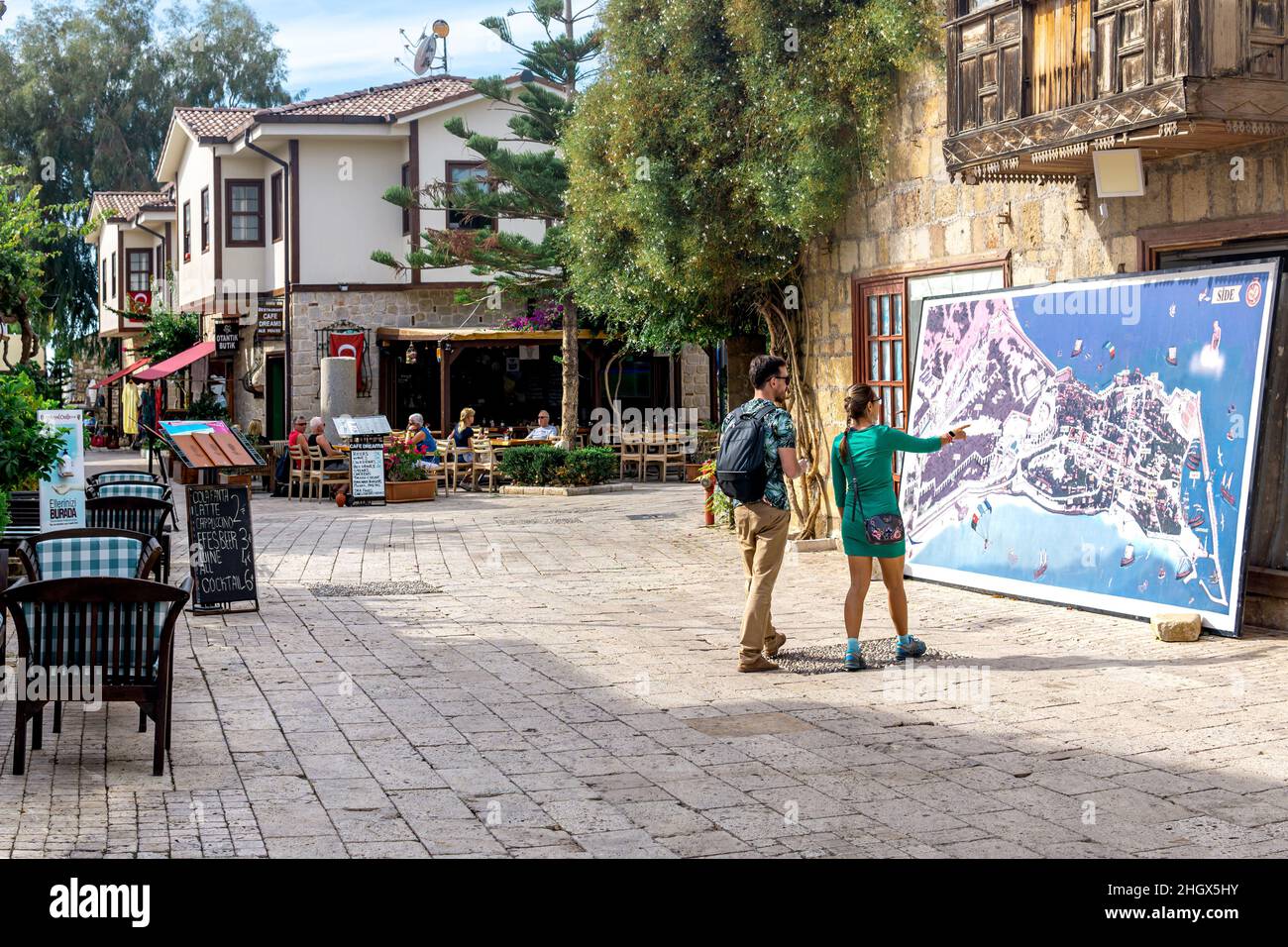 Manavgat, Turkey - November 13, 2021: tourists look at the street map of the historical area of Side Stock Photo