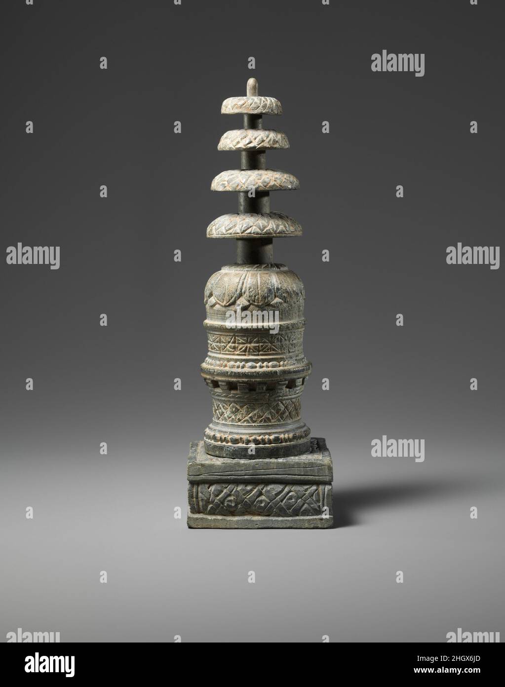 Reliquary in the Form of a Miniature Stupa 2nd–3rd century Pakistan (ancient region of Gandhara) Miniature reliquaries in the form of a stupa such as the example seen here, provide a clear architectural representation of the monumental stupas of the Gandharan region, none of whose superstructures survive intact today.. Reliquary in the Form of a Miniature Stupa. Pakistan (ancient region of Gandhara). 2nd–3rd century. Schist. Sculpture Stock Photo
