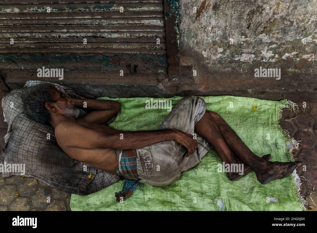 Beggar sleeps in Varanasi (Benares), India, streets Stock Photo