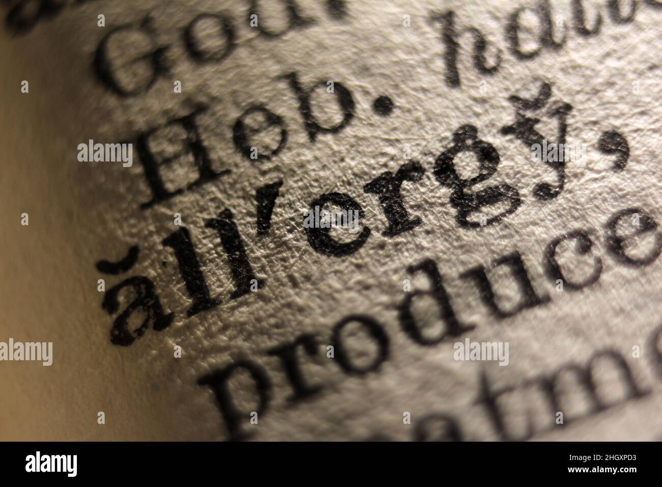 Word 'allergy' printed on dictionary page, macro close-up Stock Photo