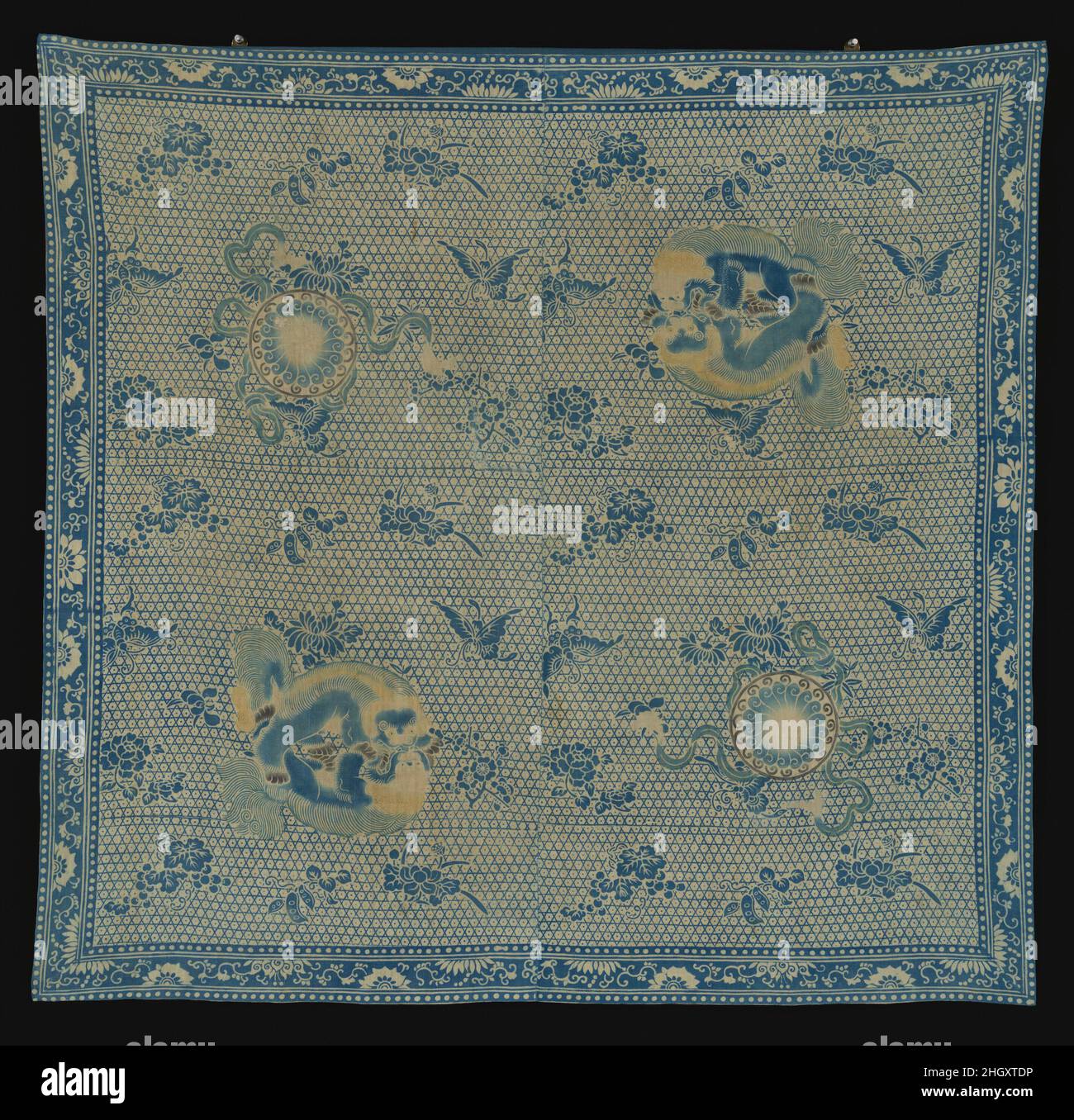 Wrapping cloth 19th century China Wrapping cloth was used to bundle material for carrying and was popular in East Asia before the introduction of the modern backpack. Resist- and stencil-dyed patterns of two pairs of stylized badgers hugging each other appear on opposite corners. The Chinese word for “badger” (huan) is pronounced the same as the word for “happiness.” Two badgers, therefore, symbolize double happiness, a common pun in Chinese art.. Wrapping cloth. China. 19th century. Cotton with resist and stencil dyeing. Qing dynasty (1644–1911). Textiles-Painted and Printed Stock Photo