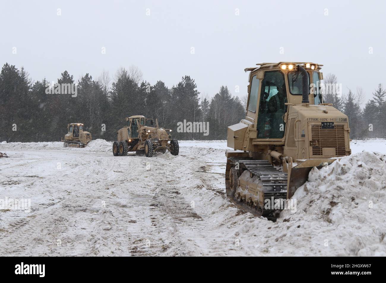 GRAYLING, Mich. – U.S. Army Soldiers from the 173rd Engineer Battalion, 32nd Infantry Brigade Combat Team, Wisconsin National Guard, build a forward operating base with multi-layered defense during Northern Strike 22-1 on January 21, 2022. ”Winter Strike” is a National Guard Bureau sponsored exercise which unites service members from several U.S. states and partner forces from Jan. 21-30, 2022, at Camp Grayling Joint Maneuver Training Center and Alpena Combat Readiness Training Center, Michigan, which together comprise the National All-Domain Warfighting Center (NADWC) (U.S. Army National Guar Stock Photo