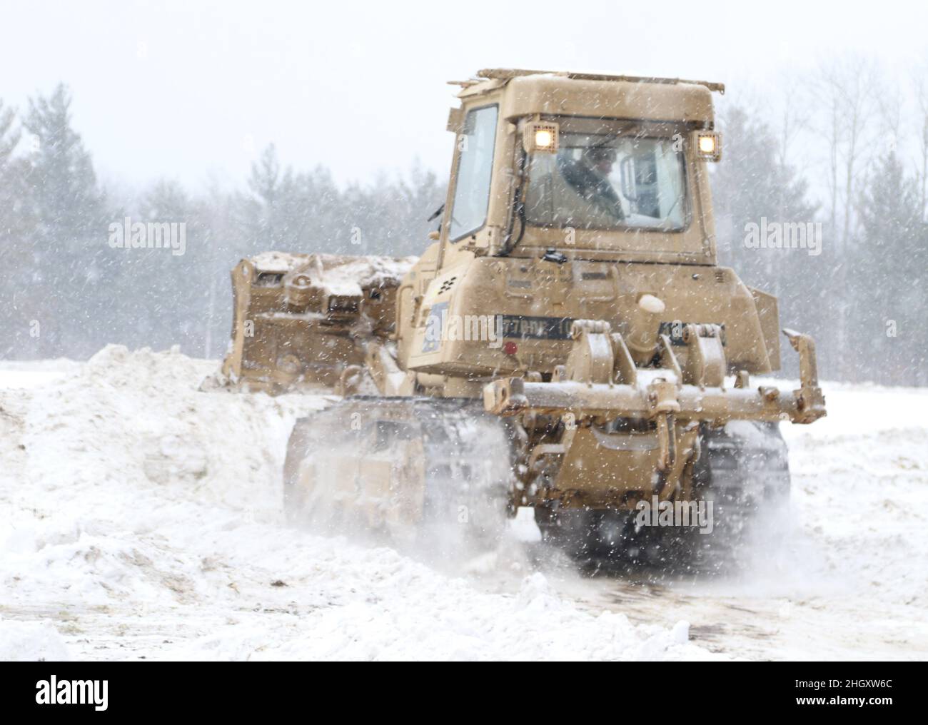 GRAYLING, Mich. – U.S. Army Soldiers from the 173rd Engineer Battalion, 32nd Infantry Brigade Combat Team, Wisconsin National Guard, build a forward operating base with multi-layered defense during Northern Strike 22-1 on January 21, 2022. ”Winter Strike” is a National Guard Bureau sponsored exercise which unites service members from several U.S. states and partner forces from Jan. 21-30, 2022, at Camp Grayling Joint Maneuver Training Center and Alpena Combat Readiness Training Center, Michigan, which together comprise the National All-Domain Warfighting Center (NADWC) (U.S. Army National Guar Stock Photo