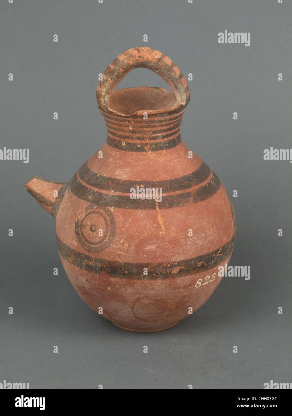 Jug, spouted 750–600 B.C. Cypriot Loop handle across neck and circles.. Jug, spouted. Cypriot. 750–600 B.C.. Terracotta. Cypro-Archaic I. Vases Stock Photo