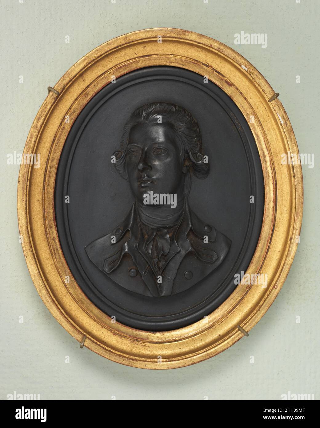 William Pitt, the Younger ca. 1787 Wedgwood and Co. Cameo medallions with portrait reliefs were made by Josiah Wedgwood between 1765 and 1795, with Thomas Bentley as his partner from 1769 to 1780. Black basalt and jasper are both types of fine stoneware hard enough for the delicate modeling which distinguishes Wedgwood's portrait cameos of 'Illustious Ancents and Moderns.'. William Pitt, the Younger. British, Etruria, Staffordshire. ca. 1787. Black basalt ware. Wedgwood and Co.. Ceramics-Pottery Stock Photo