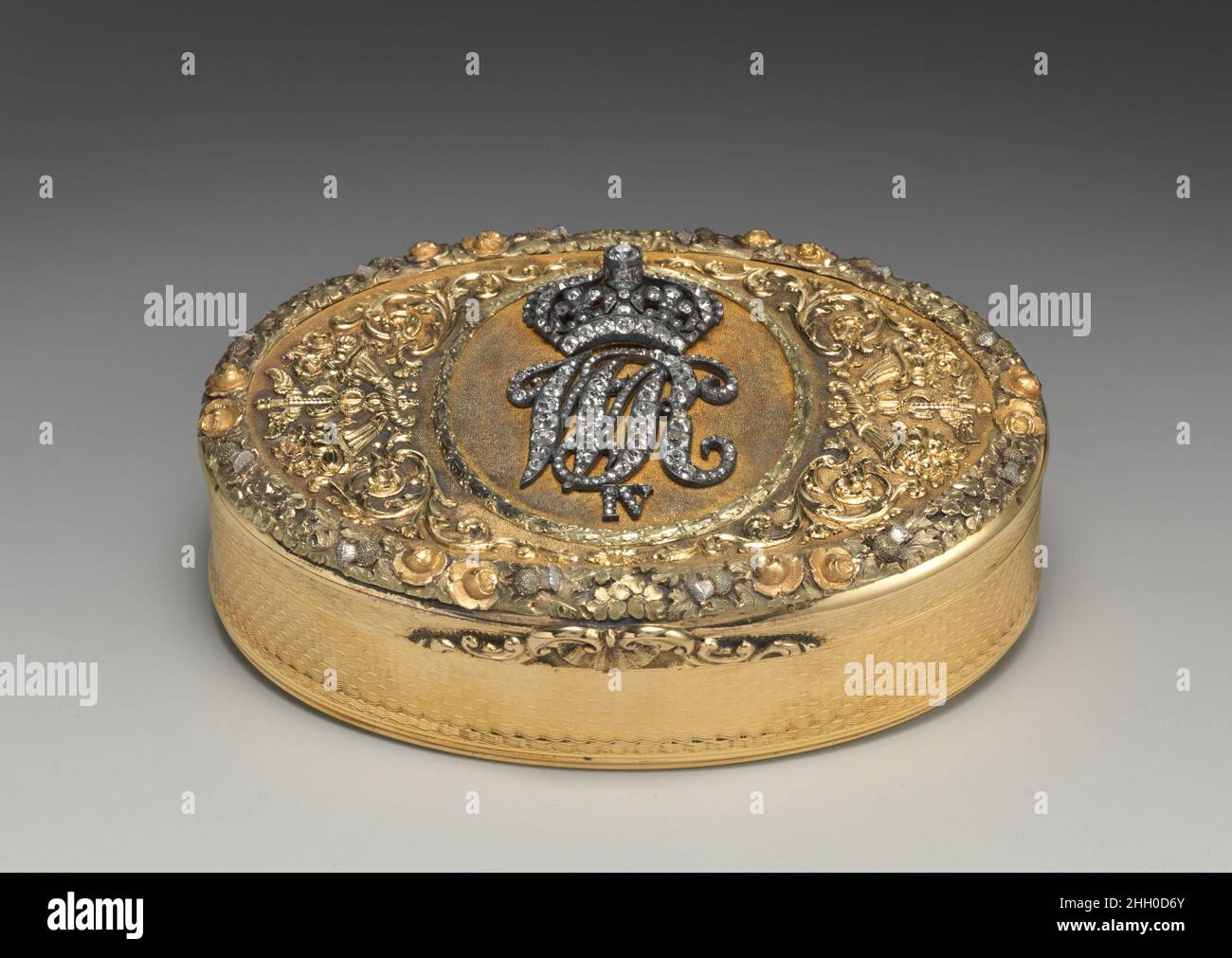 Snuffbox with cipher of William IV of the United Kingdom of Great Britian and Ireland 1825–26 John Northam WR IV crowned is the monogram of King William IV (born 1765, reigned 1830-37). This otherwise plain box was embellished with an encrusted plaque bearing his monogram; the border combines roses, thistles, and shamrocks. The box was presented to Henry George Scholtz, British consul at Lisbon (1828–34) and the grandfather of the donor's husband.. Snuffbox with cipher of William IV of the United Kingdom of Great Britian and Ireland. British, London. 1825–26. Gold, diamonds, enamel. Metalwork- Stock Photo