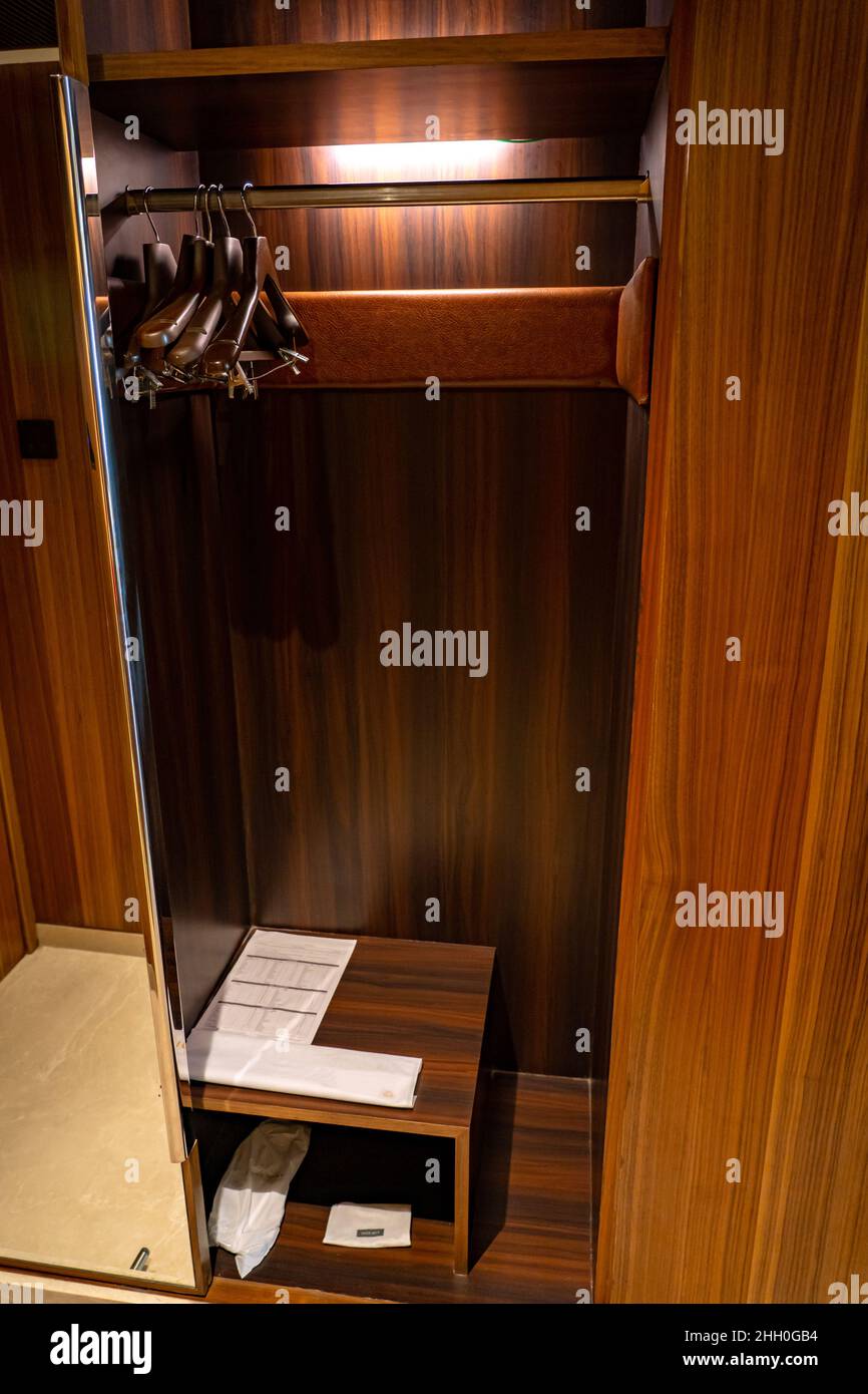 An empty wooden closet with coat hangers. Stock Photo