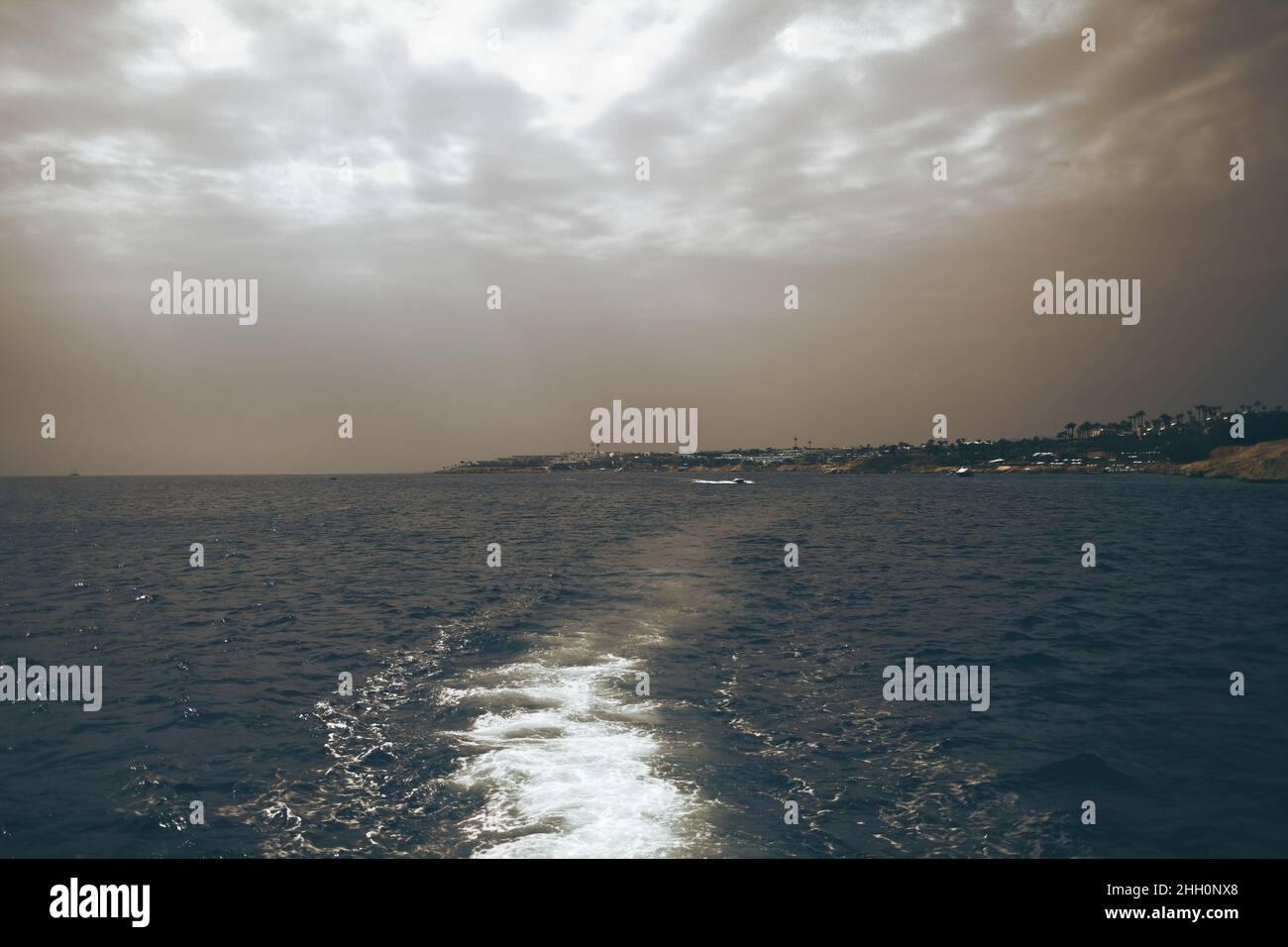 Wake on the sea surface after a cabin boat. Stock Photo