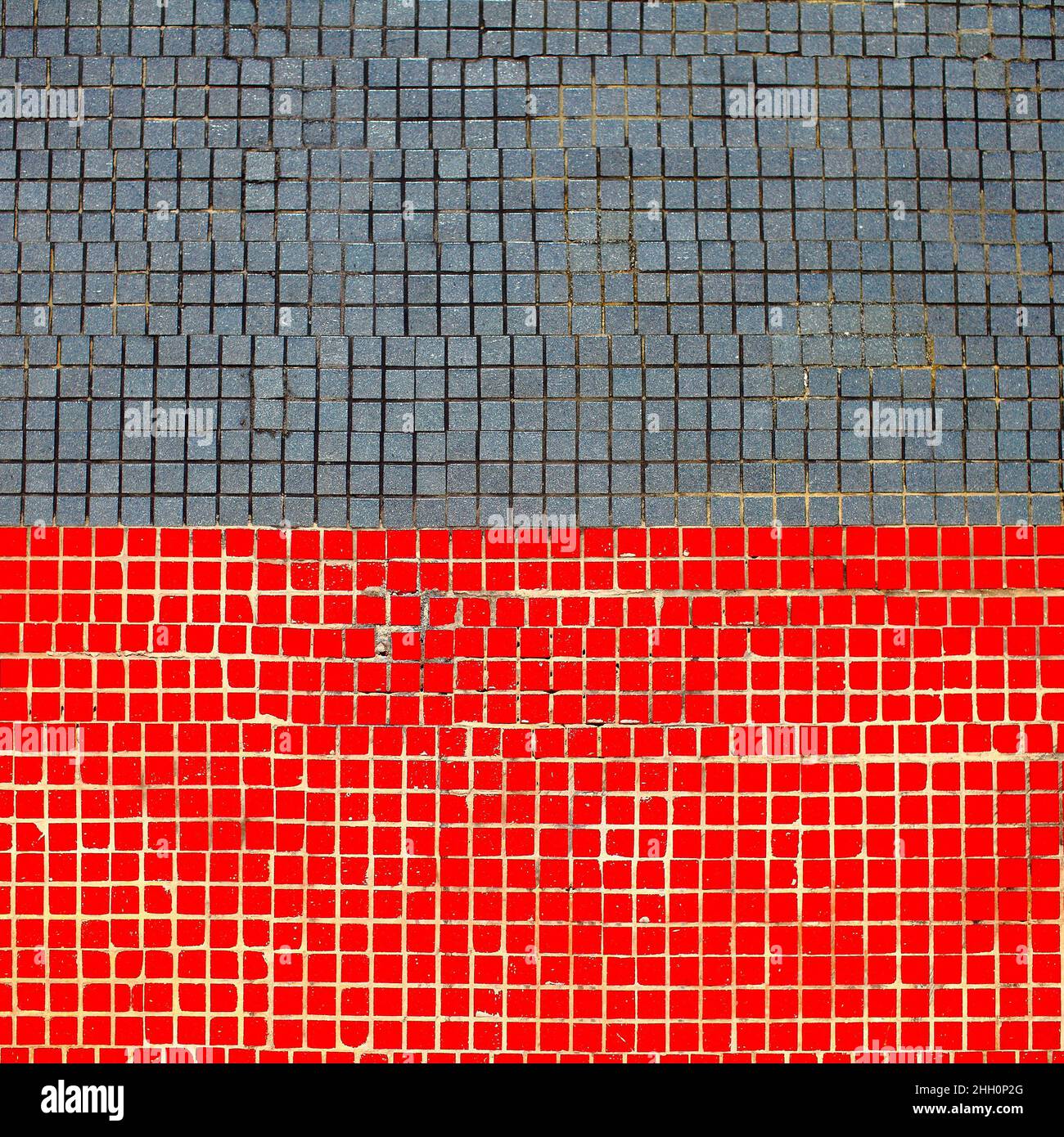 Small mosaic tiles combined in two colors, textured background. Stock Photo