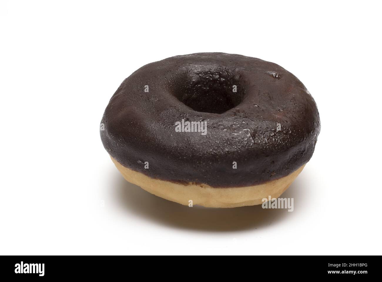 Close up of chocolate covered donut on white background Stock Photo - Alamy
