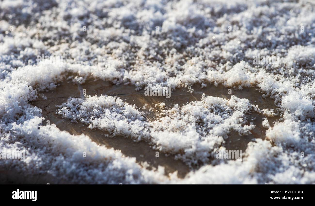 Heart made on the snow background Stock Photo - Alamy