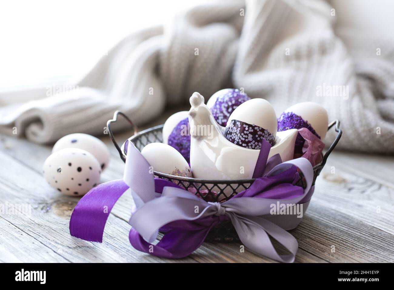 Easter composition with eggs, decorated with purple sparkles. Stock Photo