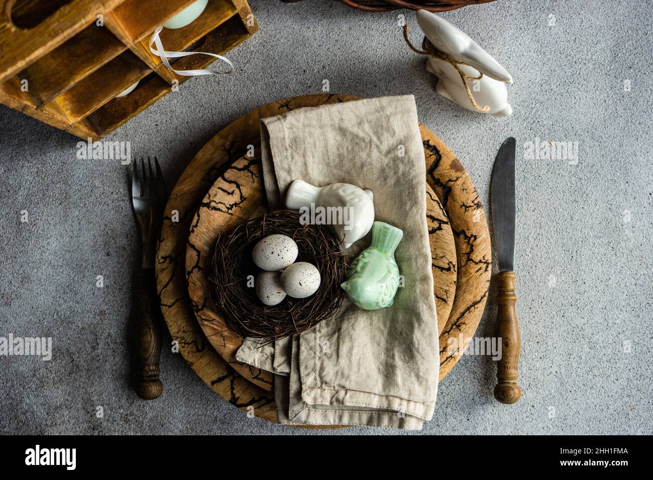 Easter dinner table settinf with colored eggs served on the table Stock Photo