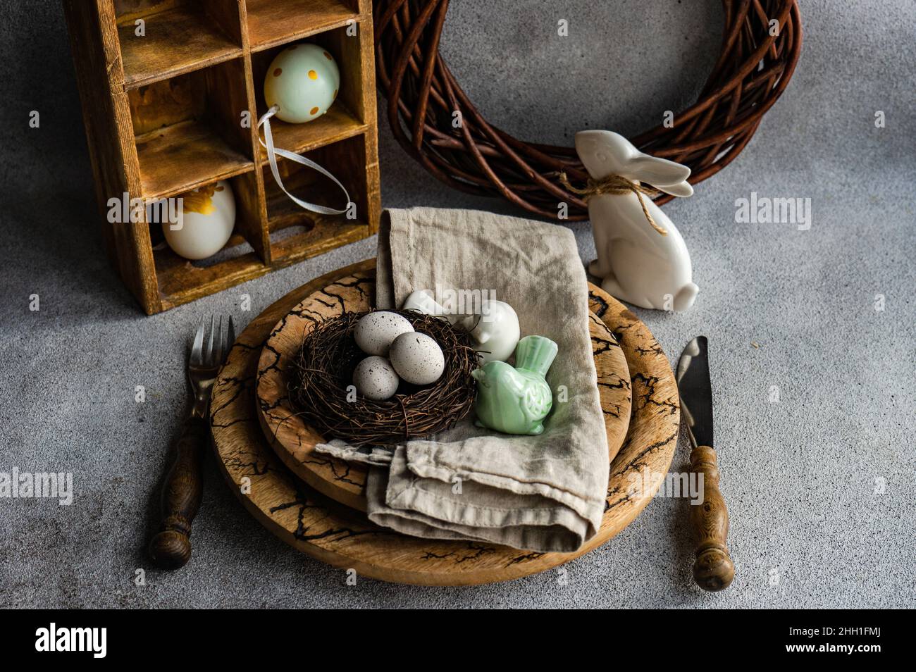 Easter dinner table settinf with colored eggs served on the table Stock Photo