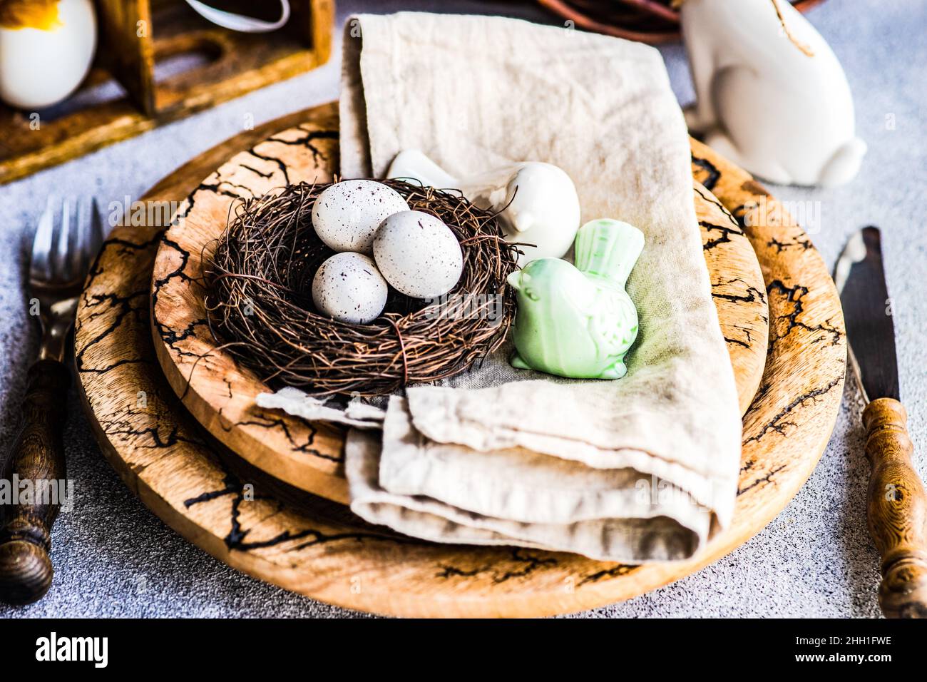 Easter dinner table settinf with colored eggs served on the table Stock Photo