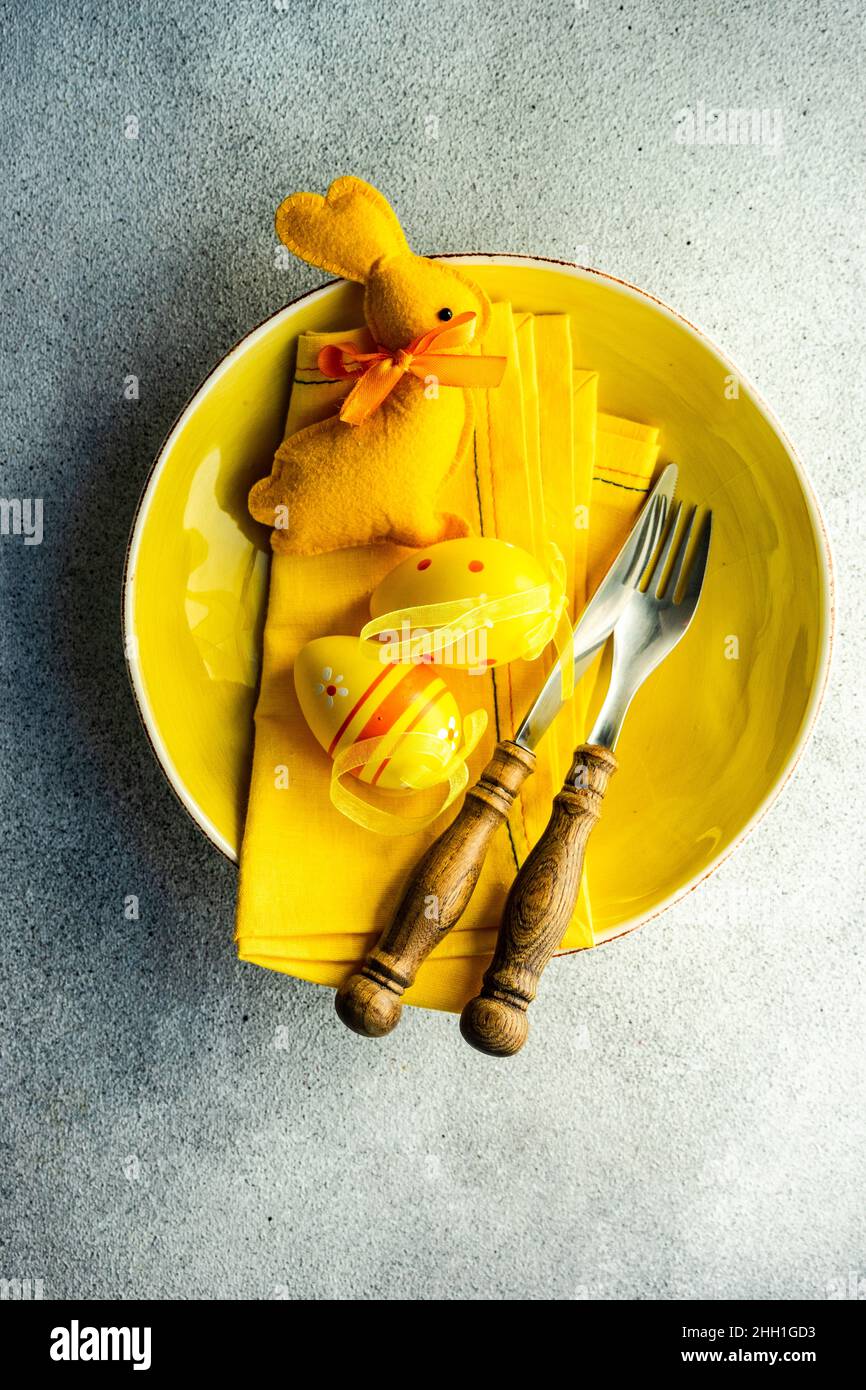 Easter dinner table settinf with colored eggs served on the table Stock Photo
