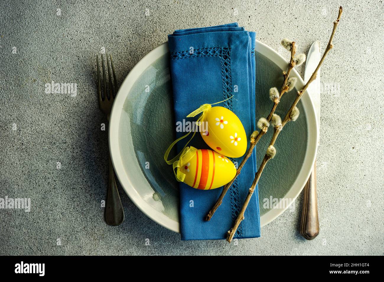 Easter dinner table settinf with colored eggs served on the table Stock Photo