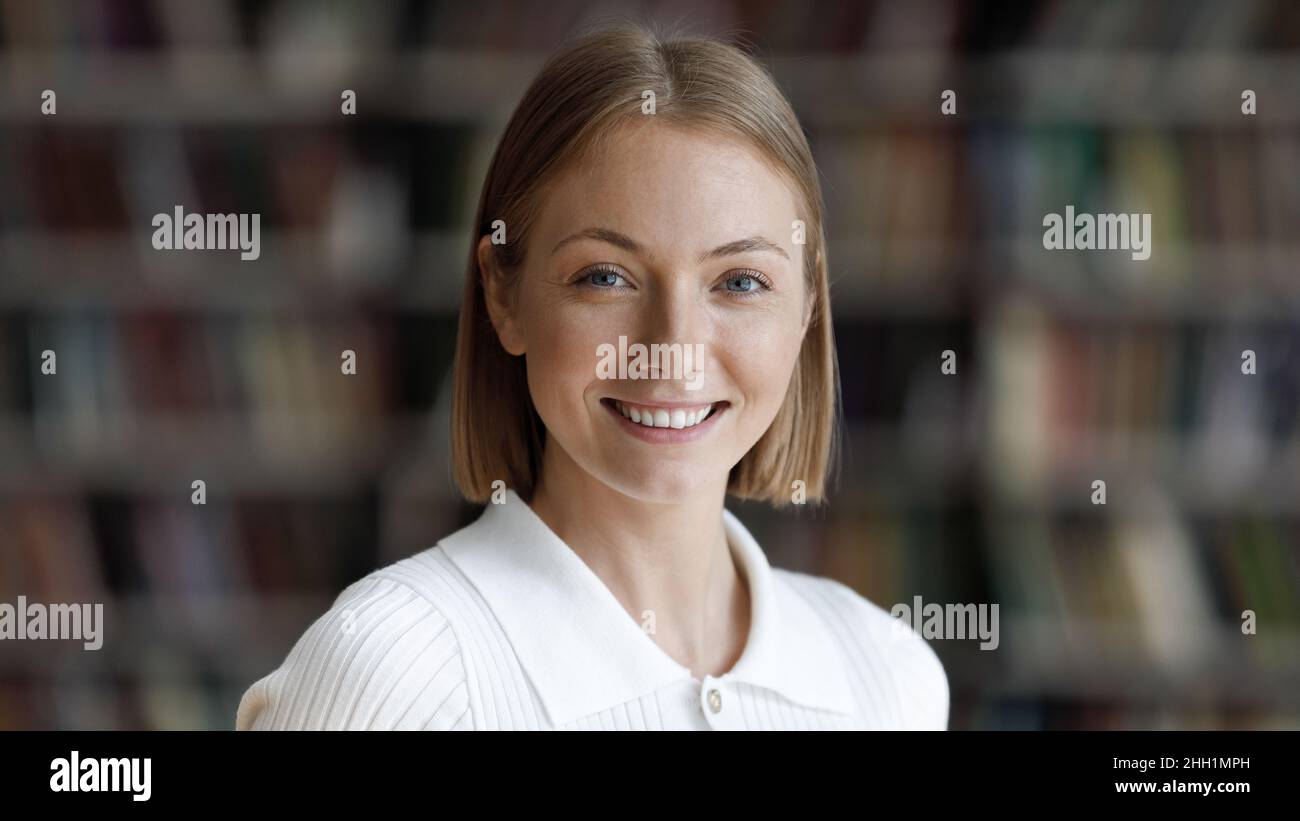 Happy college student girl posing in university library Stock Photo