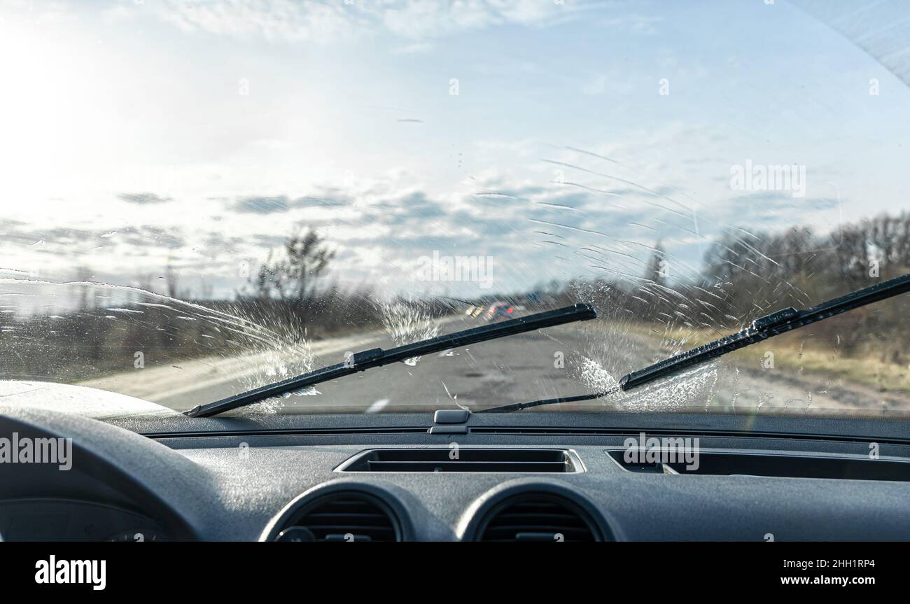 Car wipers clean windshields when driving in sunny weather Stock Photo