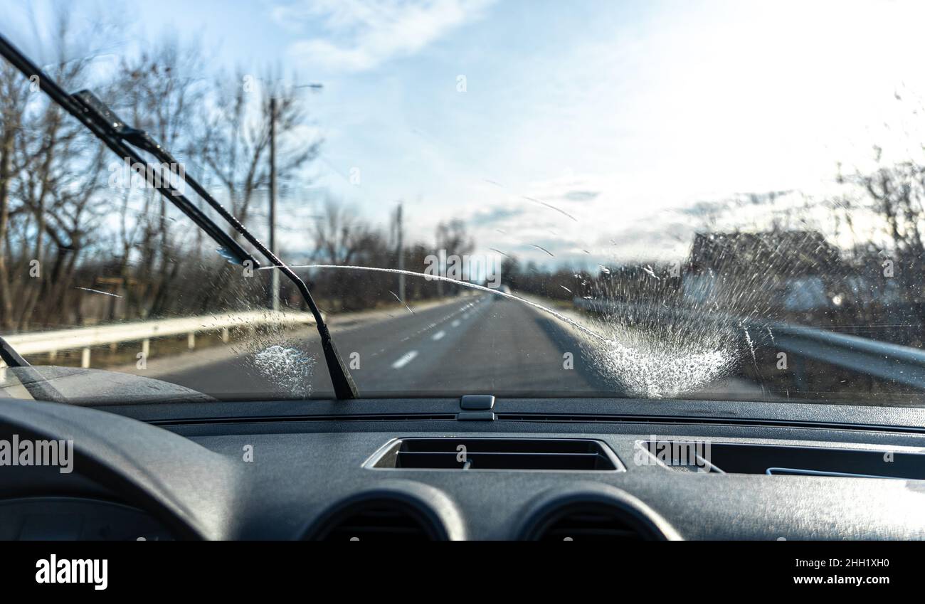 Car wipers clean windshields when driving in sunny weather Stock Photo Alamy