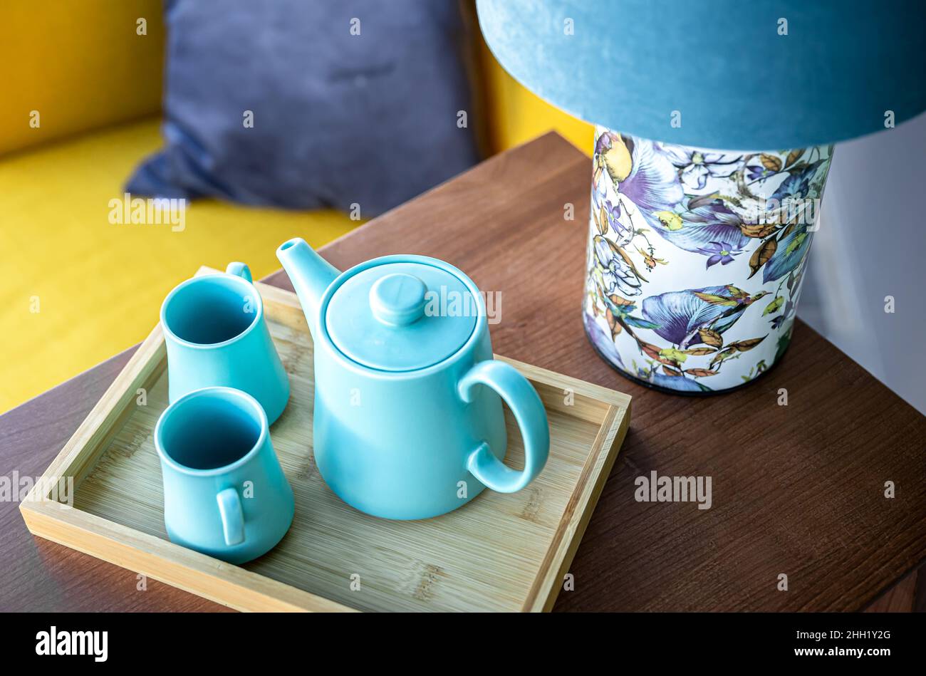 Teapot and two blue cups on the table, top view. Stock Photo