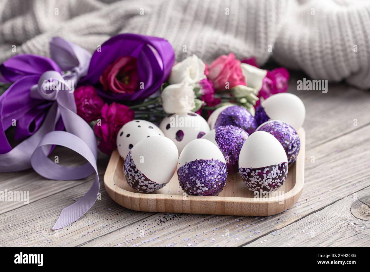 Close-up of Easter eggs decorated with purple sparkles. Stock Photo