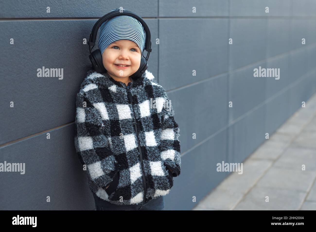 Little boy 2-3 years old enjoying his favorite music in headphones Stock Photo