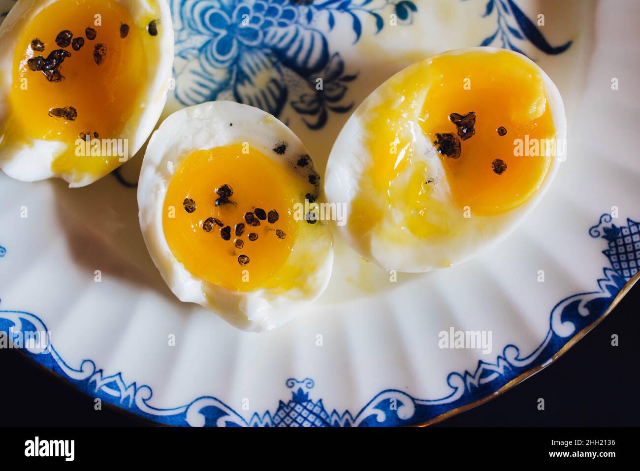 soft boiled eggs on blue and white plate Stock Photo