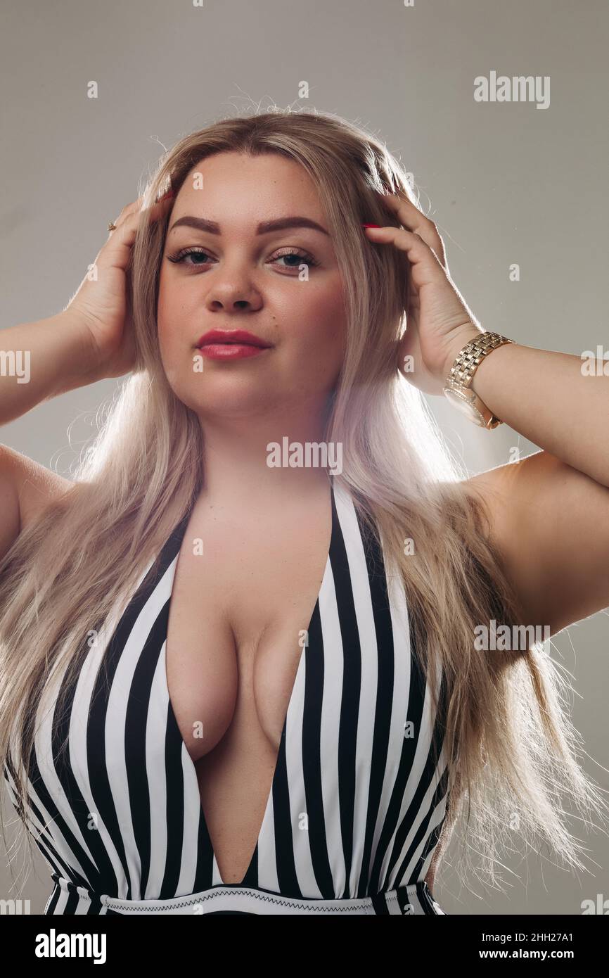 Attractive blonde woman wearing a black and white swimsuit Stock Photo -  Alamy