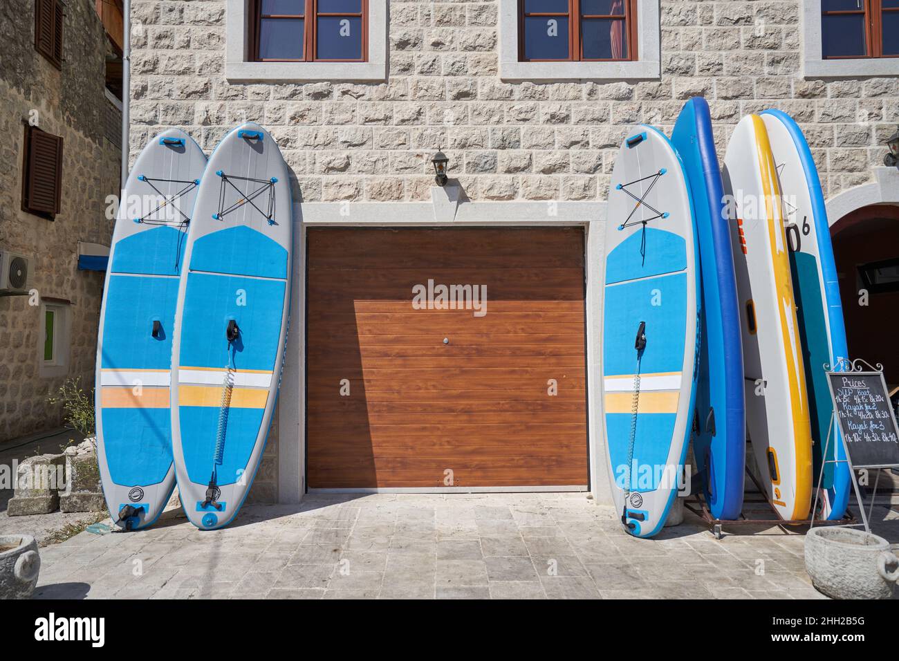 Sup boards for rent near the facade of a private house. Stock Photo