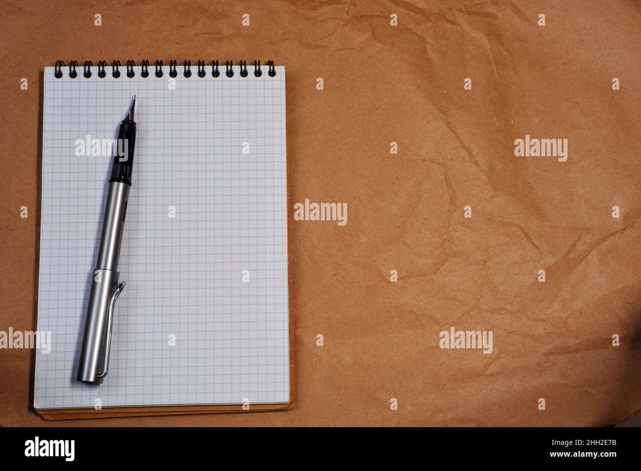 White Spiral notebook and Lamy fountain pen with copy space Stock Photo