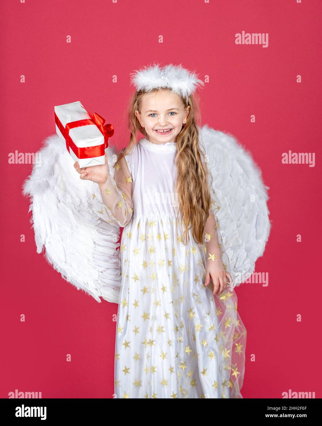 Cute angel happy smiling child girl with angels wings, isolated on red.  Valentines day Stock Photo - Alamy