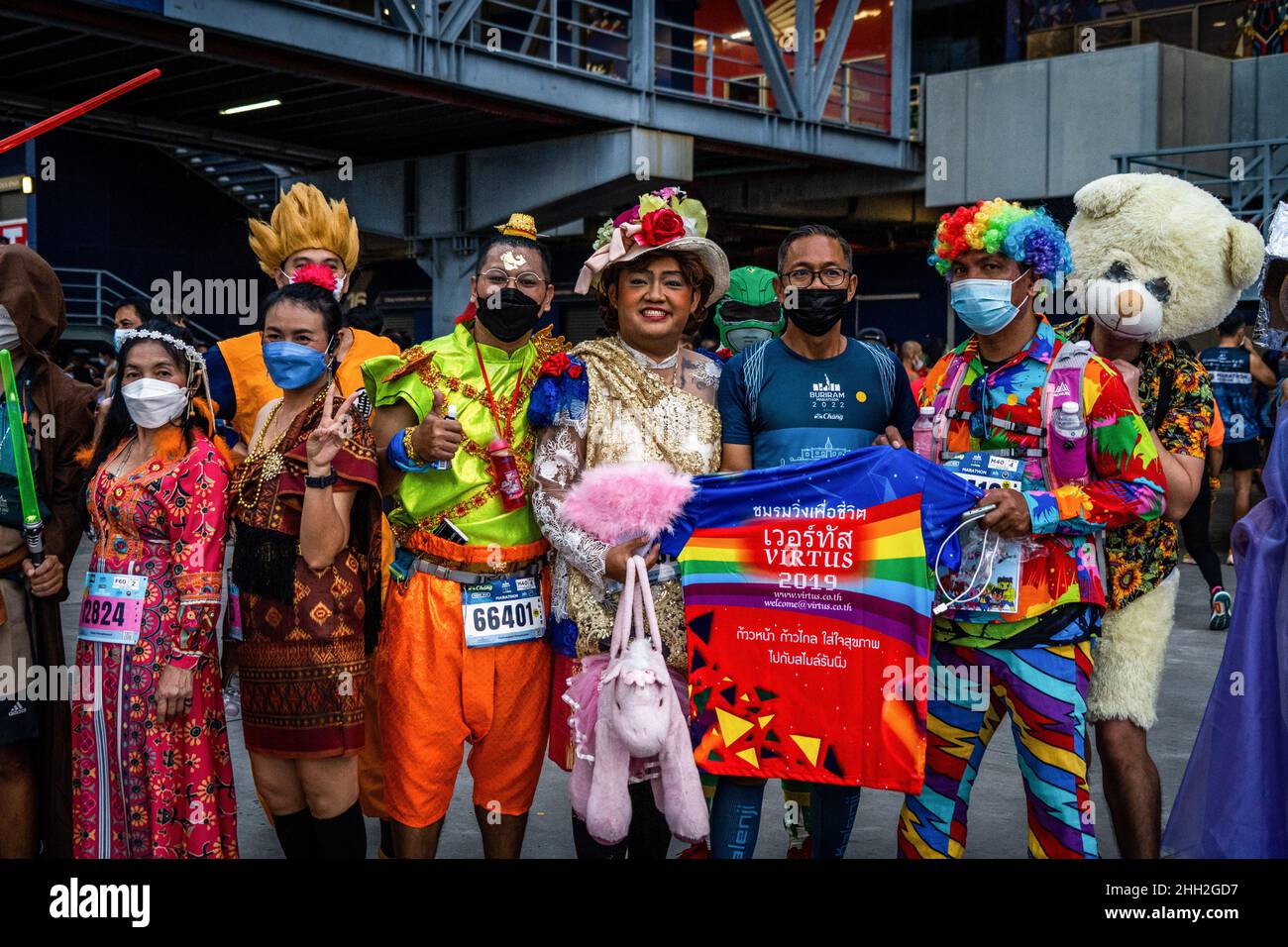 Buriram, Thailand. 23rd Jan, 2022. Costumed runners pose for a photo in front of Chang Arena before participating in the Buriram Marathon. Approximately 10,500 runners from all across Thailand participated in various races for the 2022 Buriram Marathon at Chang Arena, the first major running event in Thailand since the onset of the COVID-19. All runners completed a rapid Antigen Rapid Test (ATK) 24 hours prior to the event. Credit: SOPA Images Limited/Alamy Live News Stock Photo