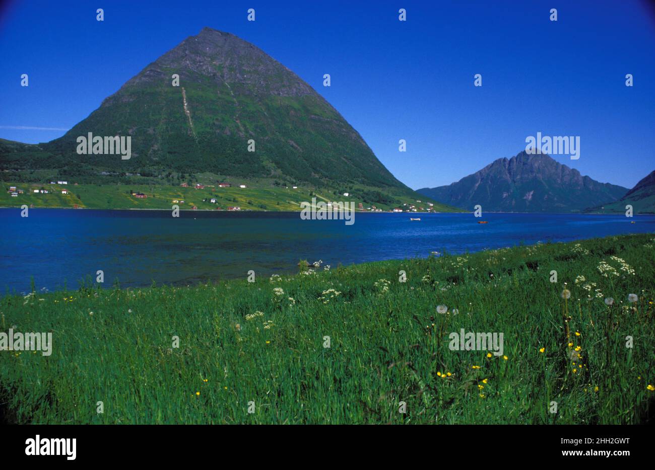 View of Aldra island from mainland, analog. Summer, flowers, mountains, and the village on the island in 1988. Stock Photo
