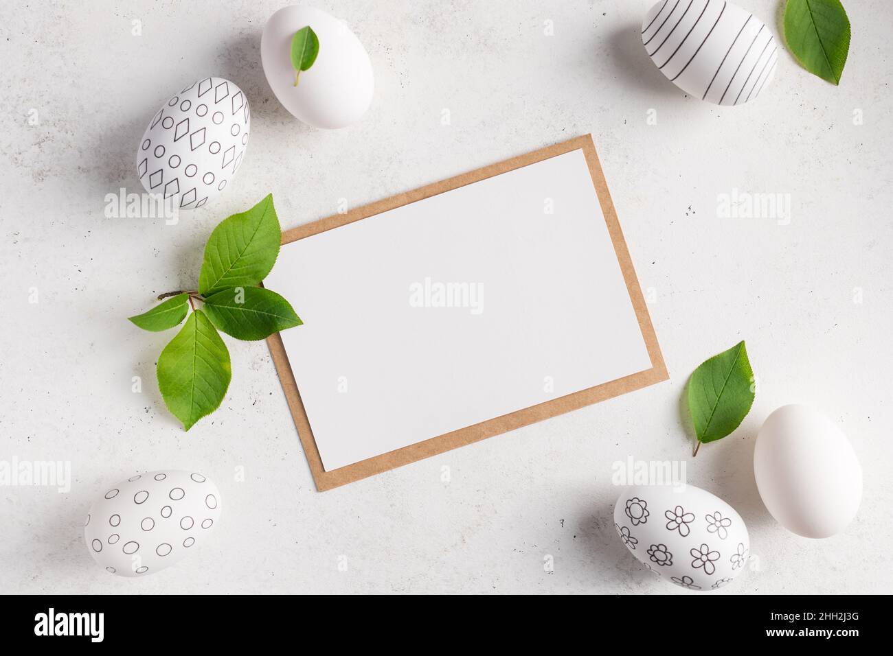 flat lay composition with blank paper card and easter eggs Stock Photo