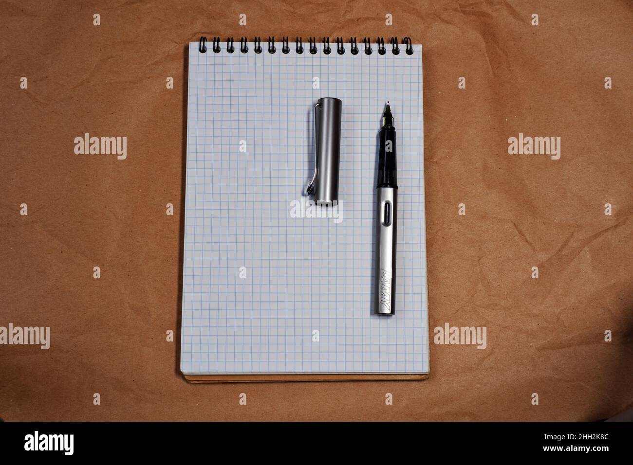 White Spiral notebook and Lamy fountain pen with copy space Stock Photo