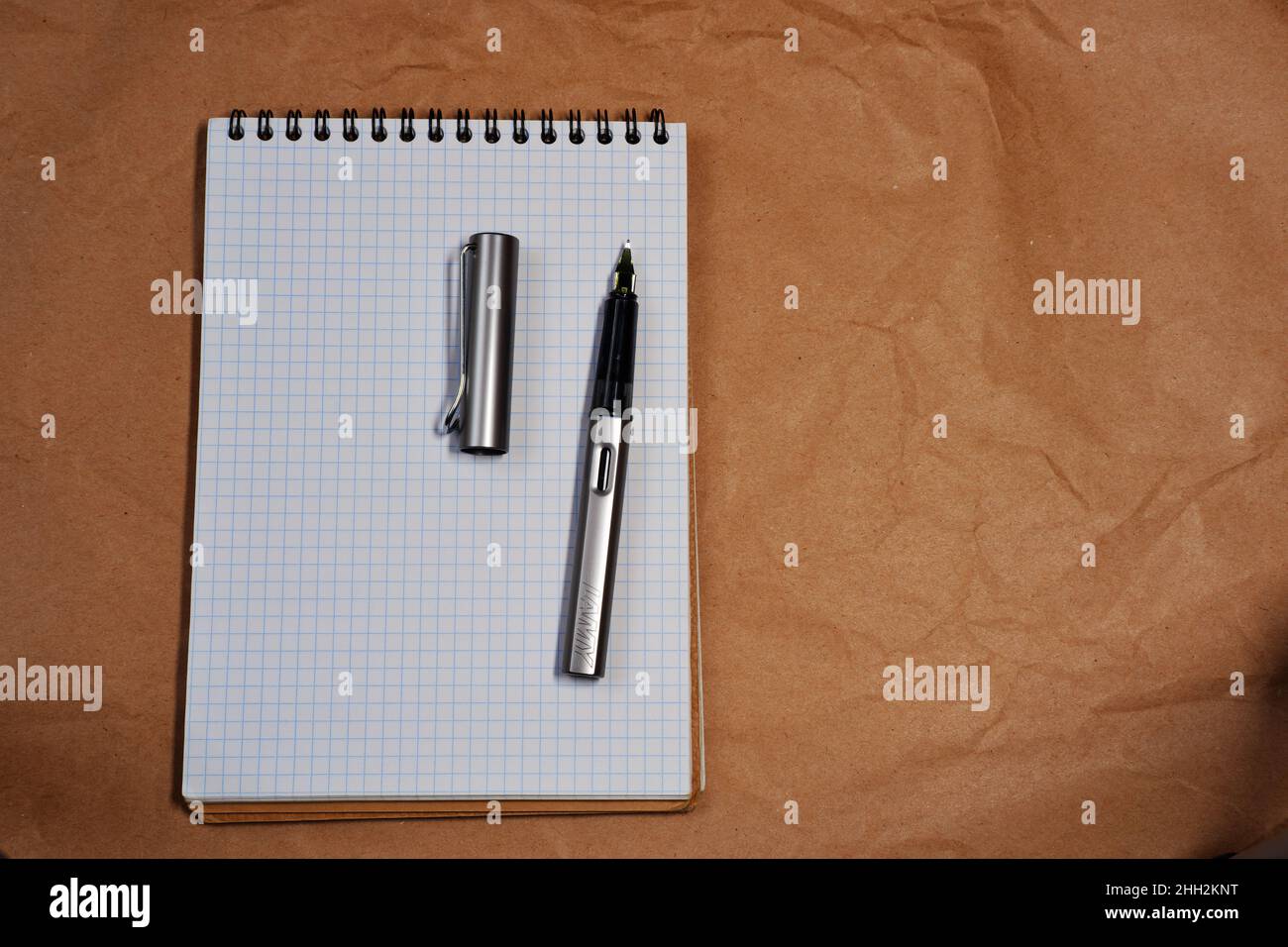 White Spiral notebook and Lamy fountain pen with copy space Stock Photo