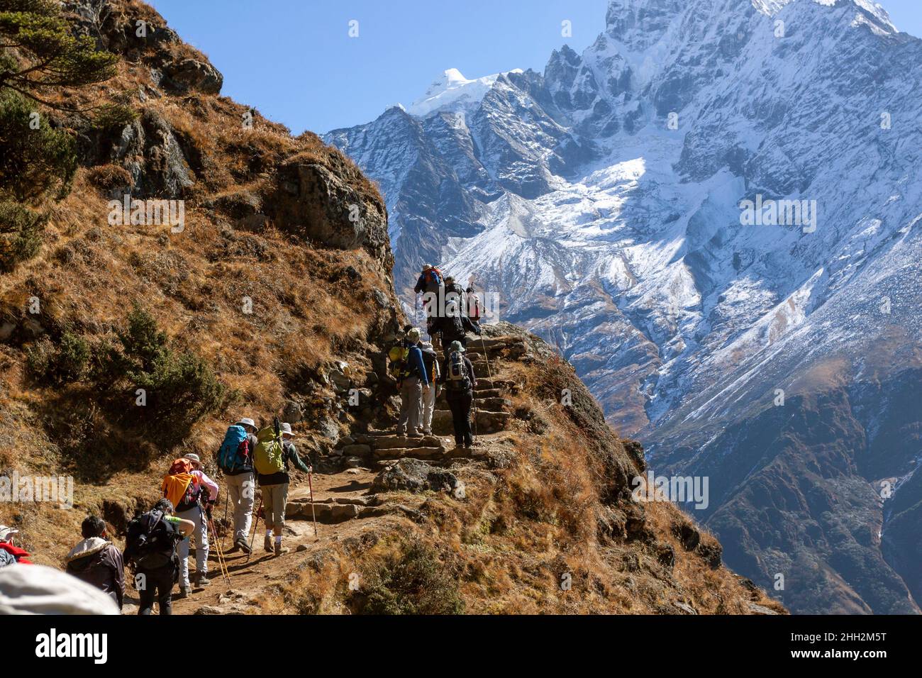 Trekking tourists climbing Everest Trek in Nepal Stock Photo