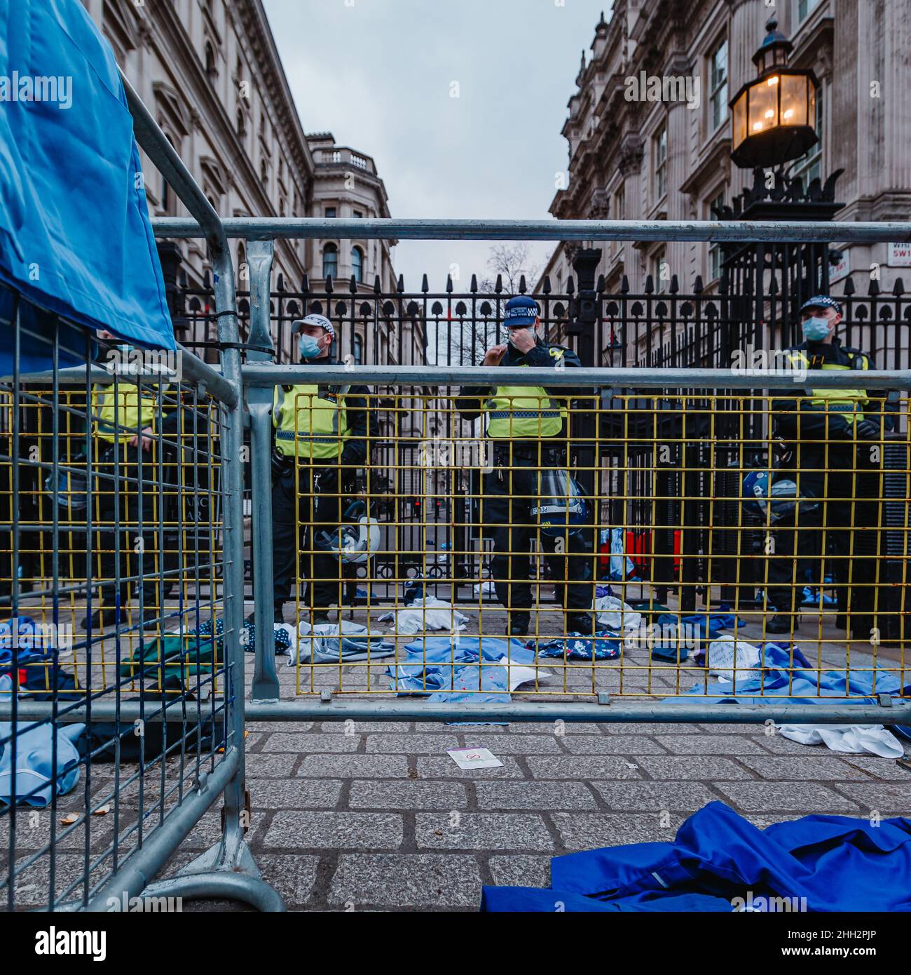 NHS staff throw scrubs at Downing Street in protest at mandatory vaccination. Stock Photo