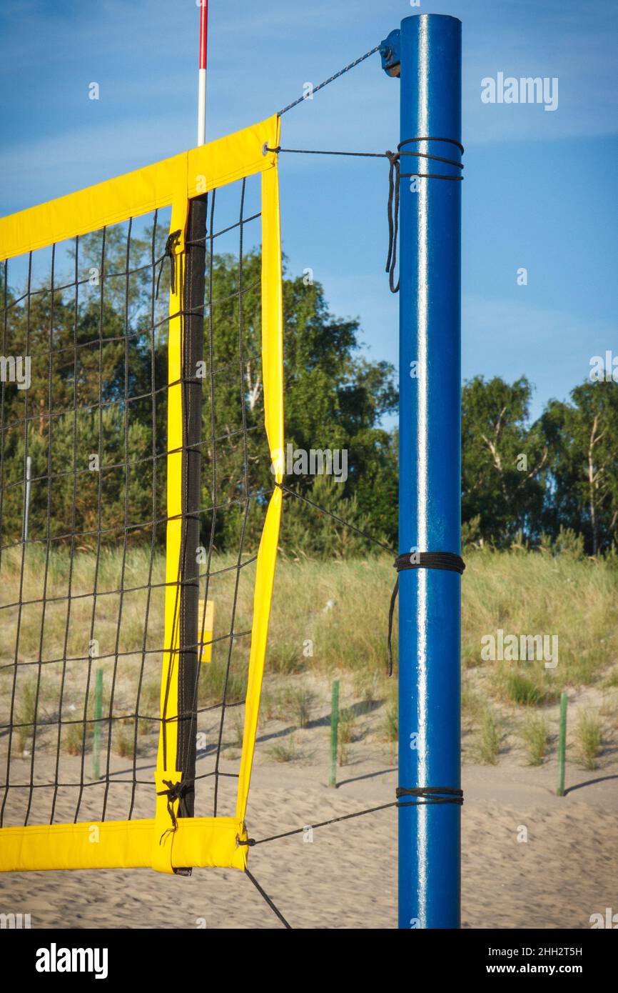 Volleyball yellow net on sand at beach. Sport, recreation and healthy lifestyles on fresh air